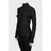 Black turtleneck with a 3D pattern and tag
