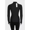 Black turtleneck with a 3D pattern and tag