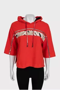 Cropped orange hoodie decorated with sequins