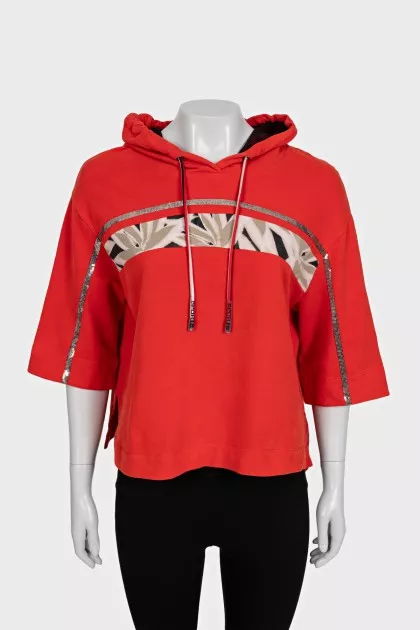 Cropped orange hoodie decorated with sequins