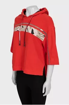 Cropped orange hoodie decorated with sequins