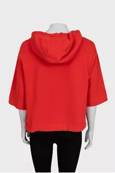 Cropped orange hoodie decorated with sequins