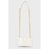 Leather bag on a metal chain, with a tag