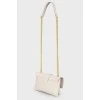 Leather bag on a metal chain, with a tag