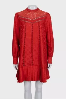 Red dress with long sleeves decorated with perforations