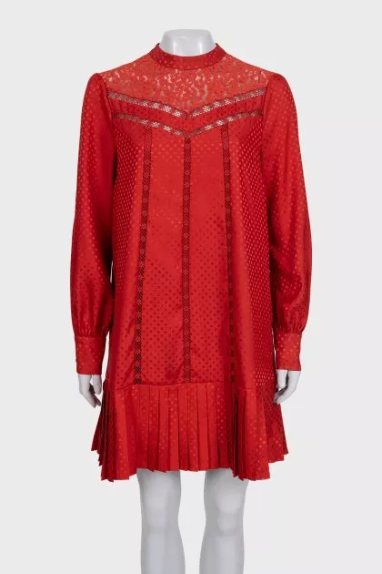 Red dress with long sleeves decorated with perforations