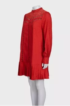 Red dress with long sleeves decorated with perforations
