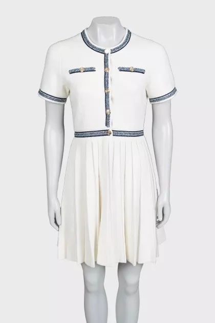 White dress with blue embroidery and tag