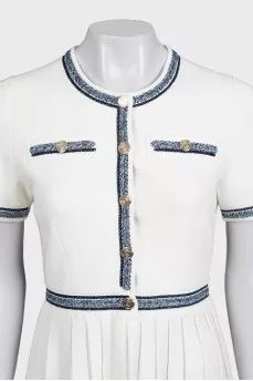 White dress with blue embroidery and tag