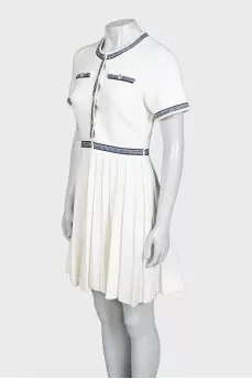 White dress with blue embroidery and tag