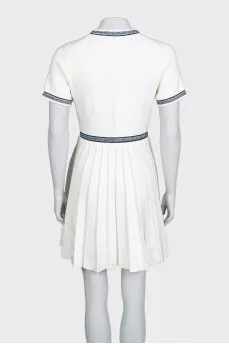 White dress with blue embroidery and tag