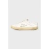 Leather sneakers with an embroidered brand's logo on the sides