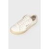 Leather sneakers with an embroidered brand's logo on the sides