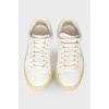 Leather sneakers with an embroidered brand's logo on the sides