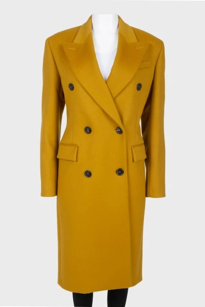Mustard coat on a double -breasted fastener, with a tag