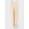Beige pants with zips at the bottom