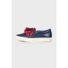 Leather slip-ons with floral appliqué