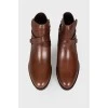 Low-heeled leather boots with tag