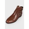 Low-heeled leather boots with tag