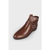 Low-heeled leather boots with tag