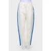 White trousers with stripes and tag