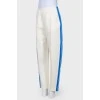 White trousers with stripes and tag