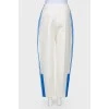 White trousers with stripes and tag
