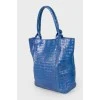 Blue bag with feather accessory
