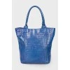 Blue bag with feather accessory