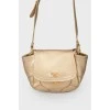 Golden bag on the shoulder belt