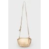Golden bag on the shoulder belt