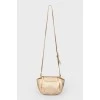 Golden bag on the shoulder belt