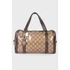 Leather bag with a golden log of brand