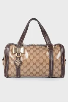 Leather bag with a golden log of brand