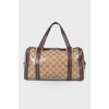 Leather bag with a golden log of brand