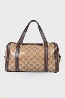 Leather bag with a golden log of brand