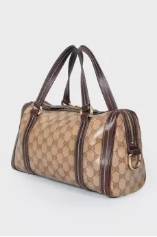 Leather bag with a golden log of brand
